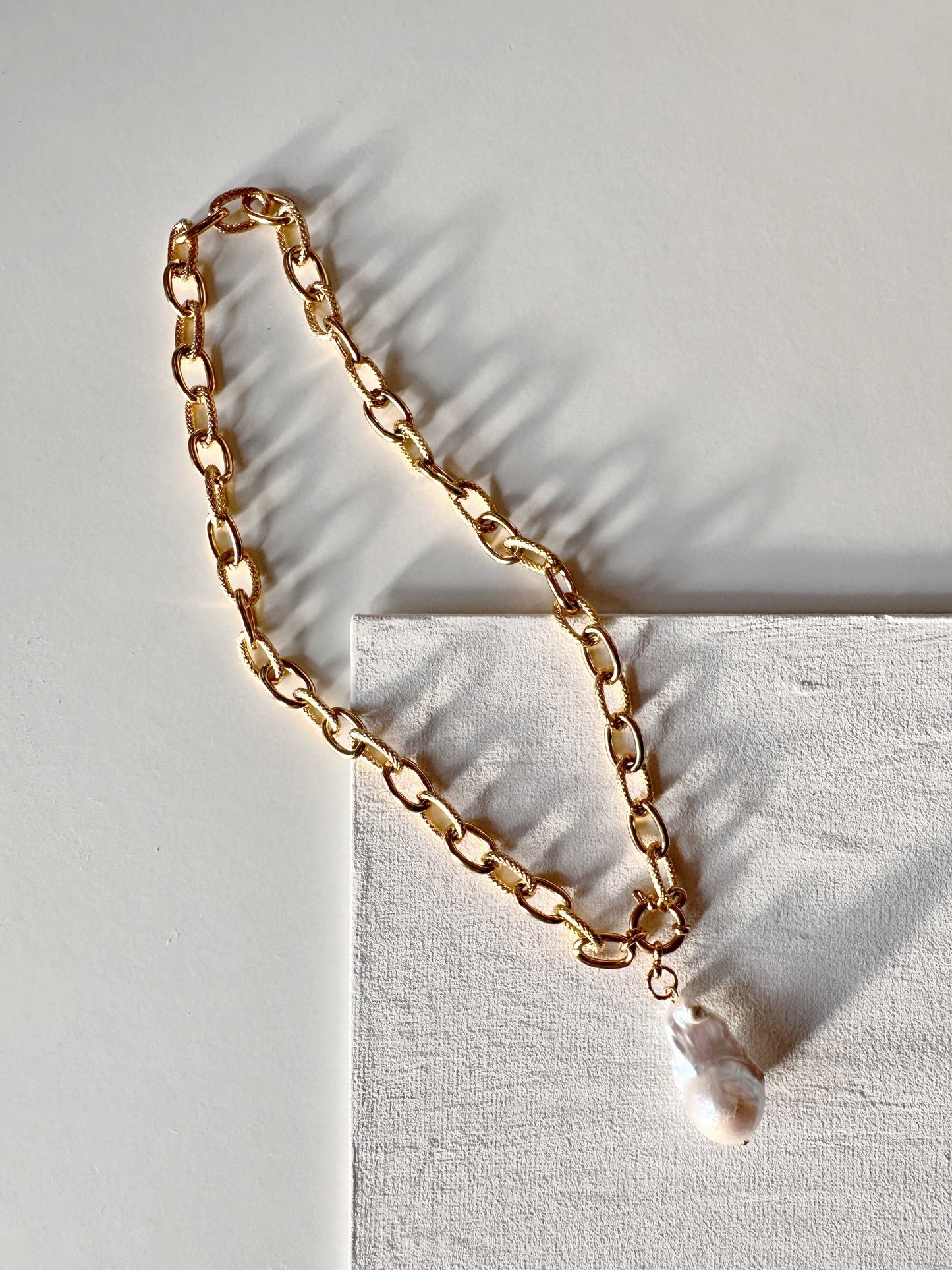 large natural pearl
chunky gold chain
large pearl necklace
classy elegant style
fashion trendy
anniversary wife
birthday gift woman
valentines gift
stylish fashionista
gold statement chain
pearl pendant chain
business attire
classic contemporary
