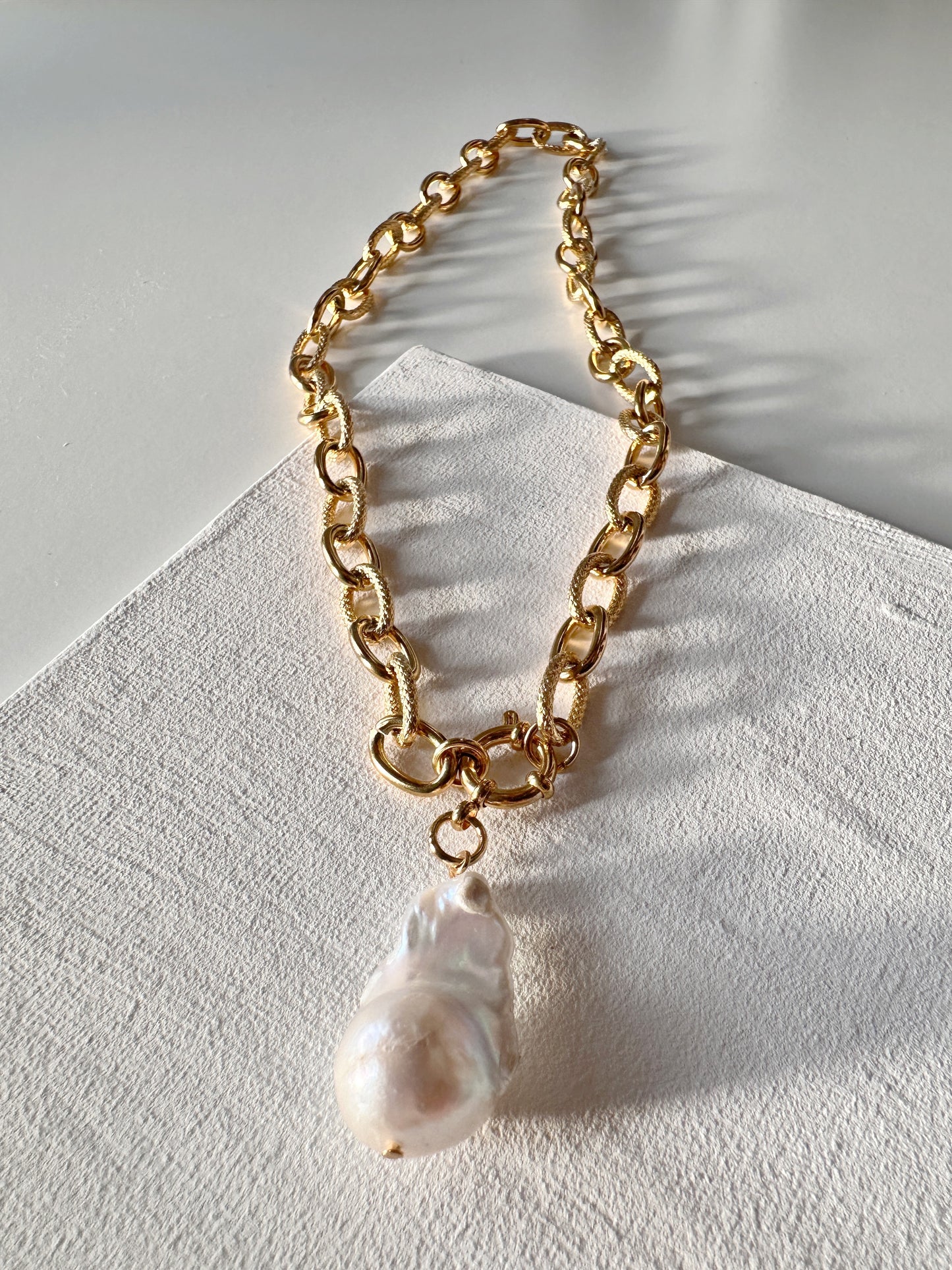 large natural pearl
chunky gold chain
large pearl necklace
classy elegant style
fashion trendy
anniversary wife
birthday gift woman
valentines gift
stylish fashionista
gold statement chain
pearl pendant chain
business attire
classic contemporary