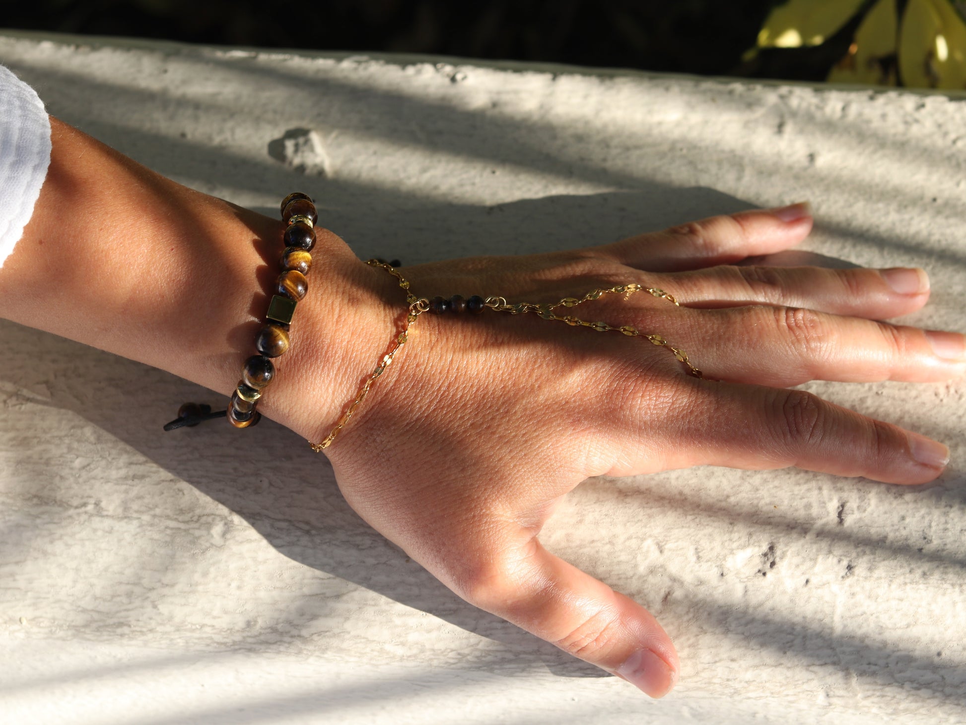 "Woman wearing Tiger's Eye hand chain showing golden brown gemstone beads personal power jewelry