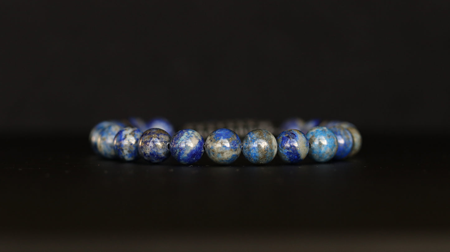 Lapis Lazuli beaded bracelet with blue and silver beads on a black background