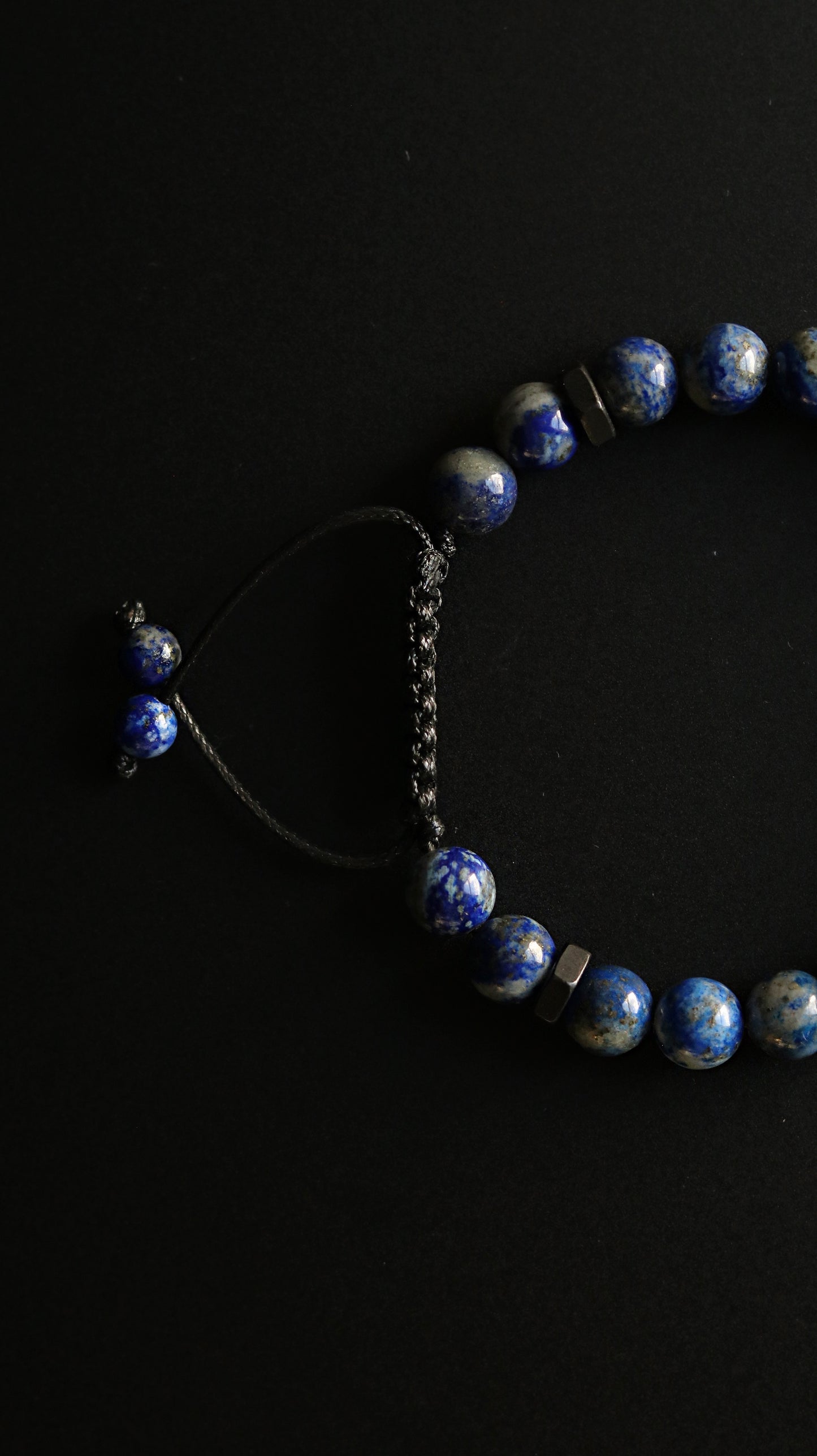Blue beaded bracelet on a black background