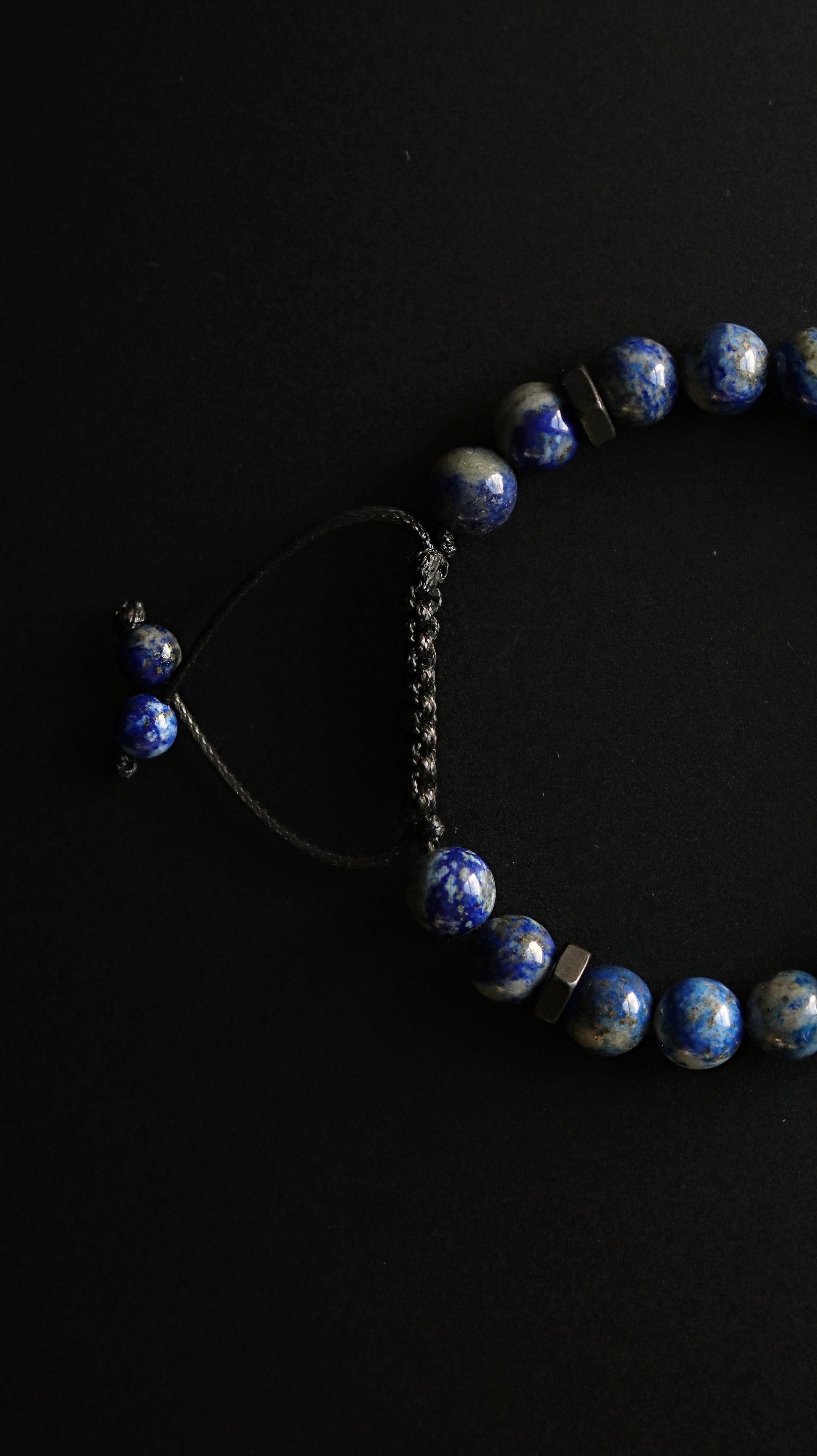Blue beaded bracelet on a black background