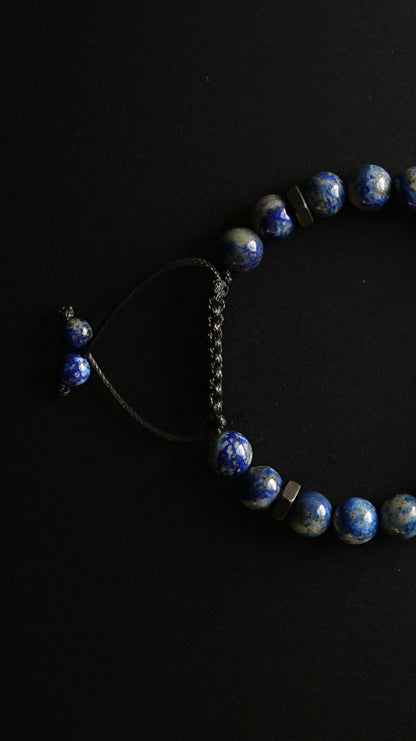 Blue beaded bracelet on a black background
