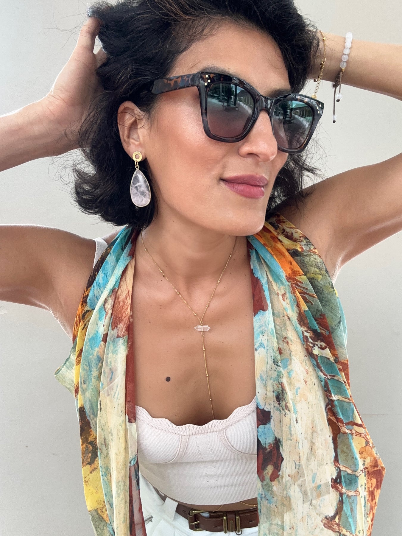 woman wearing elegant teardrop rose quartz earrings